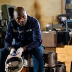 Unhappy mechanical engineer man with problem at factory